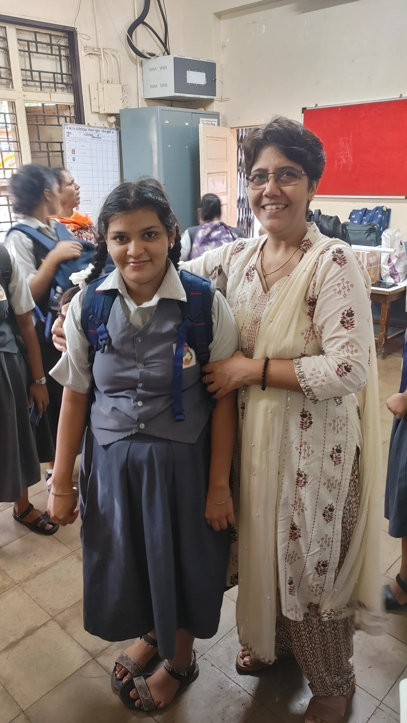 A HariKshama Foundation volunteer standing with a student at the special school in Parel